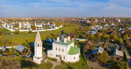 Fototapeta na wymiar Panoramic aerial view of Alexandrovsky monastery (first plan) and Pokrovsky monastery (background) on sunny autumn day. Suzdal town, Vladimir Oblast, Russia.