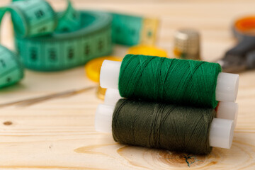 Threads and sewing accessories on wooden table