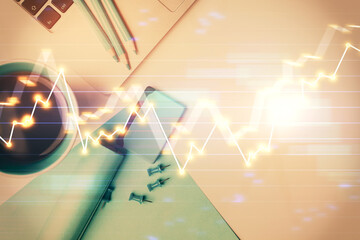 Double exposure of forex graph drawing over desktop background with computer. Concept of financial analysis. Top view.