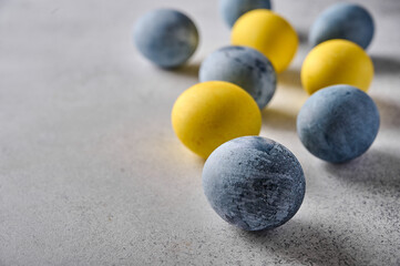 Homemade Easter colored yellow and grey marble eggs. Close up, selective focus