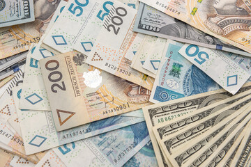 Fototapeta na wymiar pile of us dollar and polish zloty banknotes as background