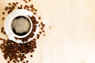 Cup of black coffee with coffee beans.