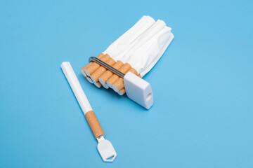 Quit smoking concept. Cigarettes squeezed into a lock on a blue background. Bad limiting habit.