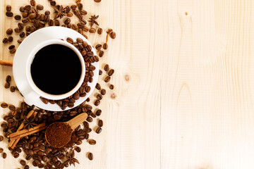 Cup of black coffee with coffee beans.