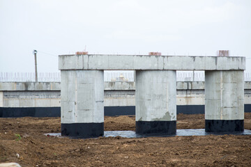 Naklejka premium Reinforced concrete supports of a transport bridge at a construction site