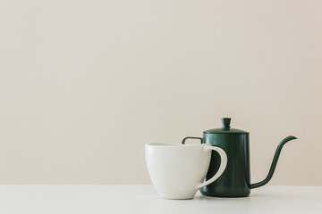 A teapot and coffee cup on table