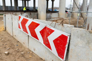 close-up of a red pointer arrow on a construction site against the background of reinforced...