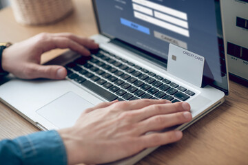 Close up picture of mans hands on a laptop