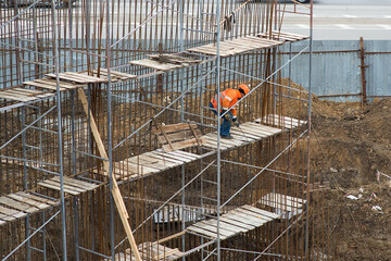 Fototapeta premium A worker makes a reinforced bridge wall structure.