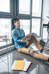 Young businessman scrutinizing project documentation and looking involved