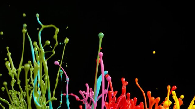 Colorful splashing paint in super slow motion.