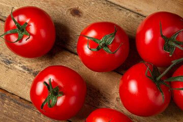 Tomatoes on a wooden background. Ripe and fresh tomatoes. Healthy vegetables.