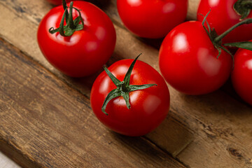 Tomatoes on a wooden background. Ripe and fresh tomatoes. Healthy vegetables.