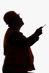 dark silhouette of thinking contruction worker profile in hard hat on white background, building...