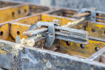 Clamp for formwork section on a construction site, close-up