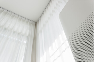 Air purifier in cozy white bedroom for filter and cleaning removing dust PM2.5