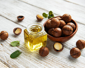 Natural macadamia oil and Macadamia nuts - obrazy, fototapety, plakaty