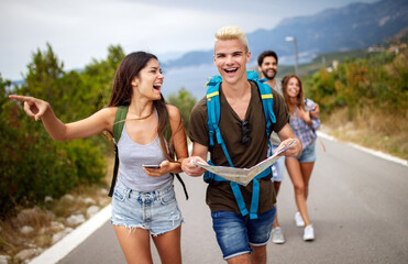 Group of backpackers and young friends traveling and having fun together