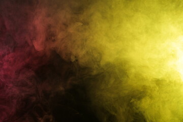 Smoke in red-yellow light on black background