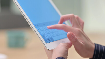 Rear View of Female Hand using Tablet