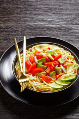 pasta with avocado, tomatoes and lime, top view