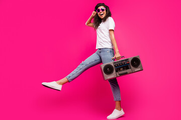 Full length body size view of lovely funny girl holding player having fun isolated over shine pink fuchsia color background