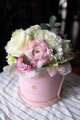 box with fresh flowers, roses, eustoma, astilba, carnation, eucalyptus, ranunculus pink for flower shop