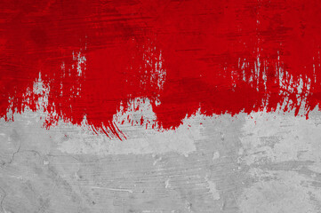 Graue Mauer mit roter dreckiger Farbfläche
