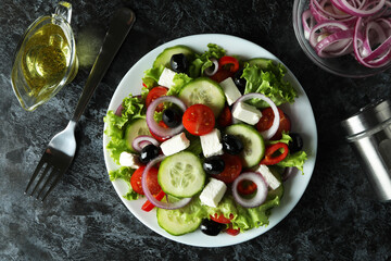 Concept of delicious food with Greek salad on black smokey background