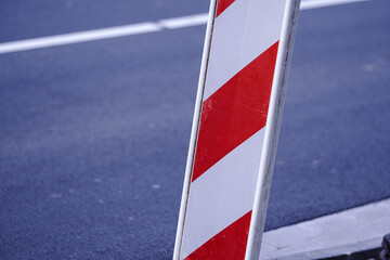 red and white striped barrier on street