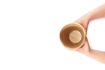 empty paper disposable glass in hands on a white background. View from above.