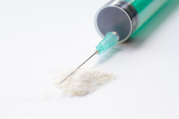 Syringe in white powder drug addiction concept