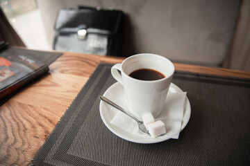 Obraz na płótnie Canvas a cup of coffee on a table in a cafe