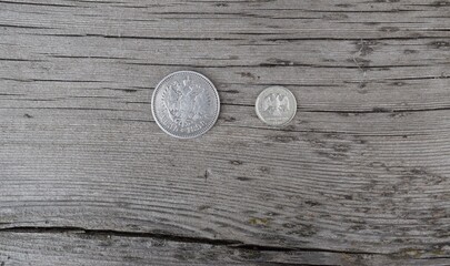  two old coins on  the  wooden background