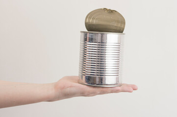 Female hand holding empty tin can. Recyclable waste. Recycling, reuse, garbage disposal, resources, environment and ecology concept
