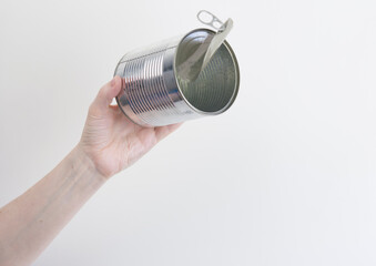 Female hand holding empty tin can. Recyclable waste. Recycling, reuse, garbage disposal, resources, environment and ecology concept
