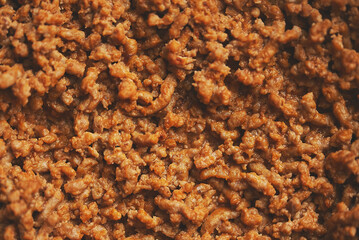 Close up of black iron pan with fried minced beef meat.