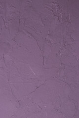 Vertical photography light purple plastered wall. Purple stucco background. Violet stone wall.