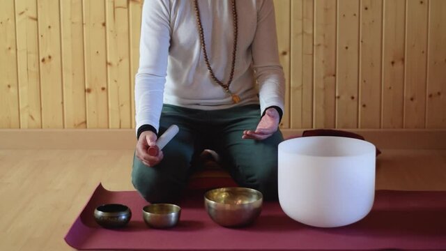 Person playing various Tibetan bowls