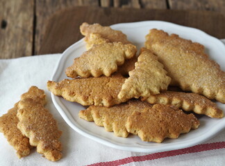 Homemade honey shortbread cookies with carved edges on a wooden background.Healthy natural food.