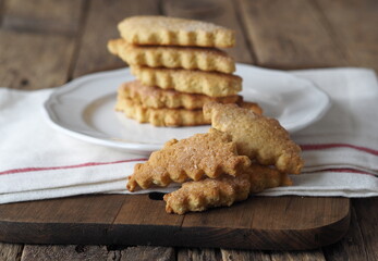 Homemade honey shortbread cookies with carved edges on a wooden background.Healthy natural food.