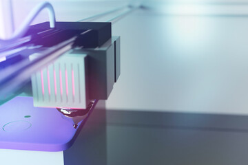 Closeup of a 3D printer printing a mobile phone case. Tinted 3D render on the development of new technologies. Research and development.