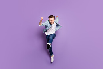 Fototapeta na wymiar Full body photo of happy crazy funky young man jump up run smile sale isolated on purple color background