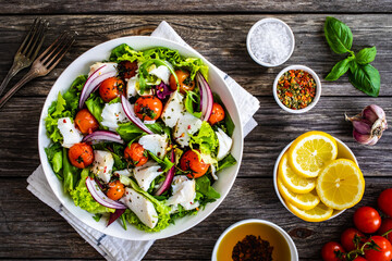 Fish dish - fried cod fillet with vegetables on wooden table
