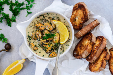 mussels in creamy sauce in a  frying pan.top view