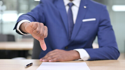 Hand of African Businessman showing Thumbs Down
