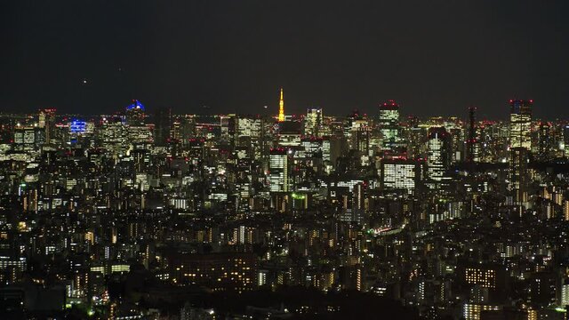 TOKYO, JAPAN : Aerial high angle CITYSCAPE of TOKYO at night. View of buildings around Shinjuku and Minato ward. Japanese city life, business and urban metropolis concept shot. Real time fixed shot.