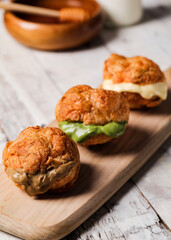 three choux creams in a wooden plate