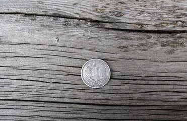 old  coin on a wooden background