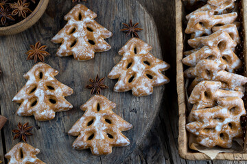 Christmas tree cookies on wooden background. New Year's food. Anise star. Festive baked goods. Gingerbread on the table.Icing sugar sweetness taste season